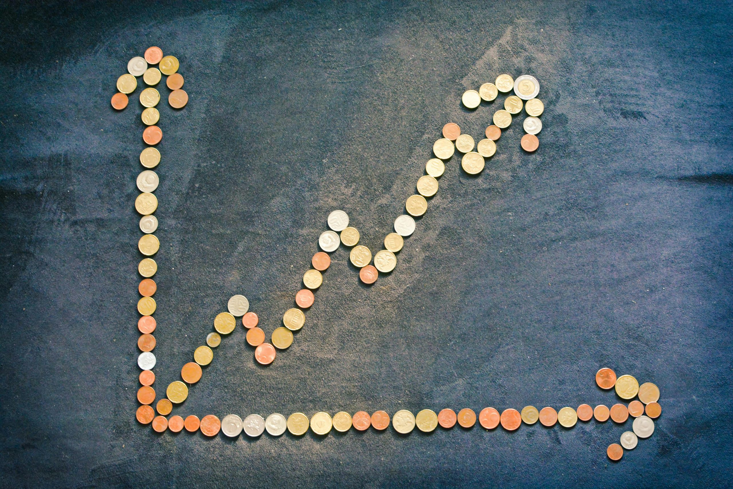 coins arranged forming a rising bar chart